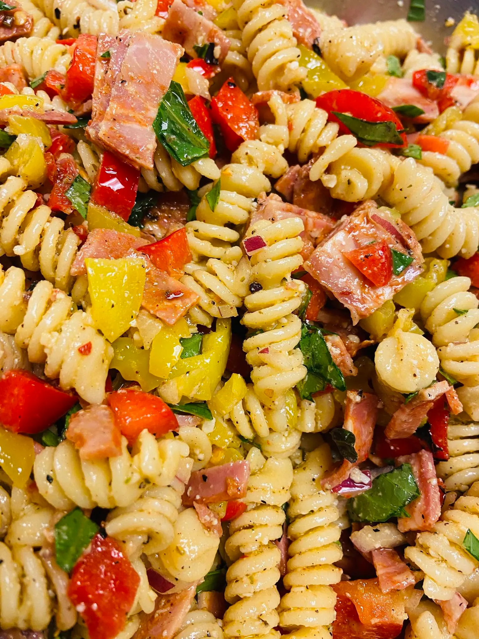 Rotini pasta salad with ham, roasted peppers, red onion and fresh basil