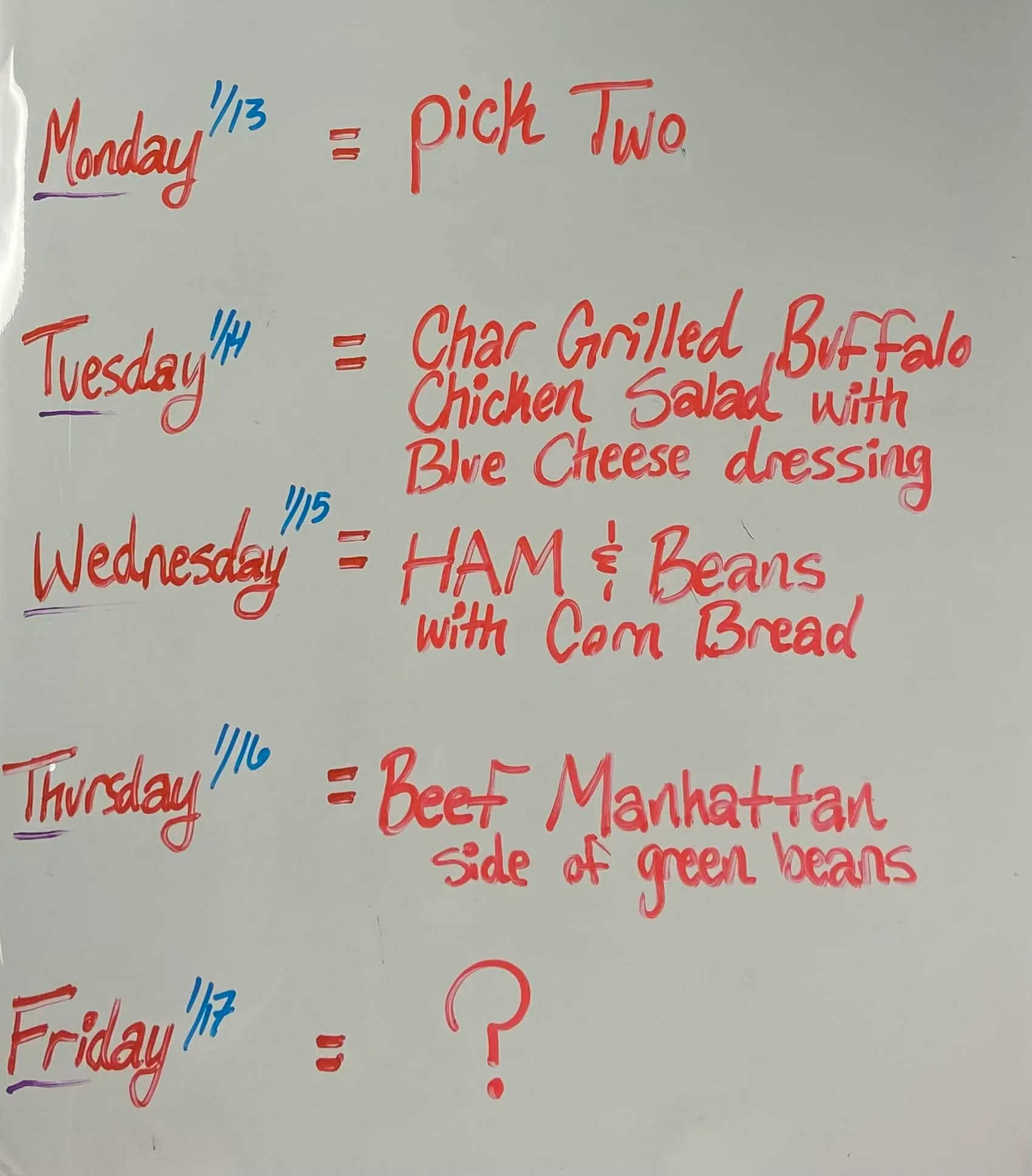 A real whiteboard from the shop listing that week's Pick Two and daily specials, Monday through Friday